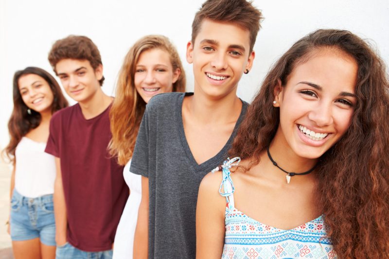 group of 5 teens smiling Clear Orthodontic Retainer